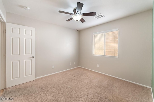 unfurnished room with carpet flooring, a ceiling fan, baseboards, and a smoke detector