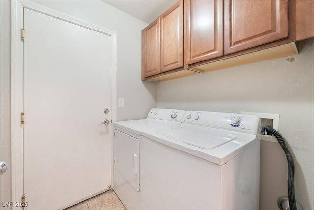 clothes washing area featuring cabinet space, separate washer and dryer, and light tile patterned flooring