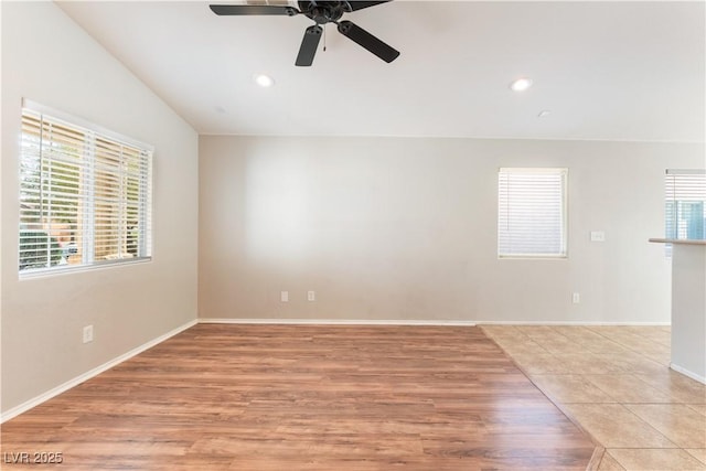 empty room featuring a ceiling fan, recessed lighting, baseboards, and light wood finished floors