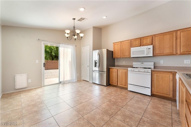 kitchen with white appliances, a chandelier, light countertops, light tile patterned floors, and hanging light fixtures
