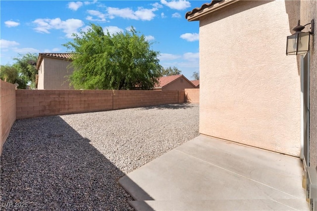 fenced backyard featuring a patio