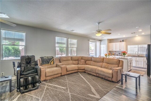 5024 Granite Creek Ct, Las Vegas, NV 89131 - living area with healthy amount of natural light, wood finished floors, a textured ceiling, a ceiling fan, and recessed lighting