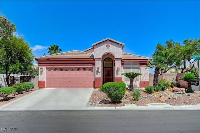 8250 Lincoln Valley St, Las Vegas, NV 89123 - mediterranean / spanish home with a garage, concrete driveway, a tile roof, fence, and stucco siding