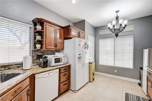 8250 Lincoln Valley St, Las Vegas, NV 89123 - kitchen with white appliances, a chandelier, backsplash, and open shelves