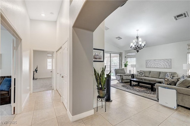 8250 Lincoln Valley St, Las Vegas, NV 89123 - living area with light tile patterned flooring, a chandelier, baseboards, and high vaulted ceiling