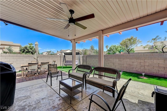 8250 Lincoln Valley St, Las Vegas, NV 89123 - view of patio / terrace with a fenced backyard, outdoor dining area, an outdoor hangout area, a ceiling fan, and area for grilling