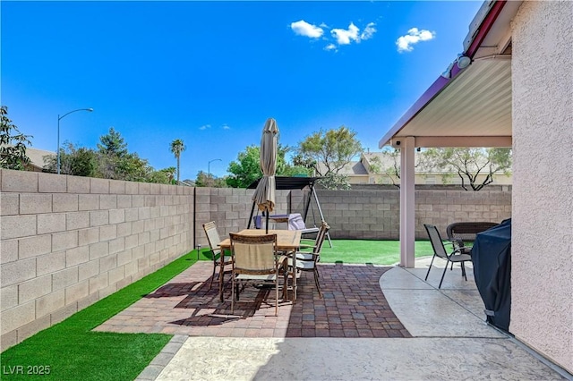 8250 Lincoln Valley St, Las Vegas, NV 89123 - view of patio featuring a fenced backyard and outdoor dining area
