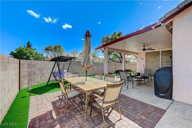 8250 Lincoln Valley St, Las Vegas, NV 89123 - view of patio / terrace with outdoor dining area, a ceiling fan, a fenced backyard, and area for grilling