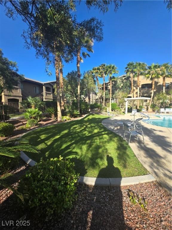 8985 S Durango Dr Unit 1154, Las Vegas, NV 89113 - view of yard featuring a patio area and a community pool