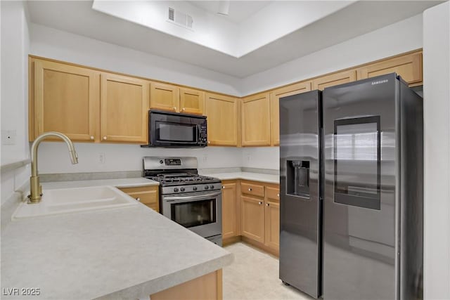 8985 S Durango Dr Unit 1154, Las Vegas, NV 89113 - kitchen with stainless steel appliances, light brown cabinets, a sink, and light countertops