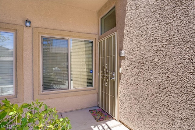 8985 S Durango Dr Unit 1154, Las Vegas, NV 89113 - doorway to property with stucco siding