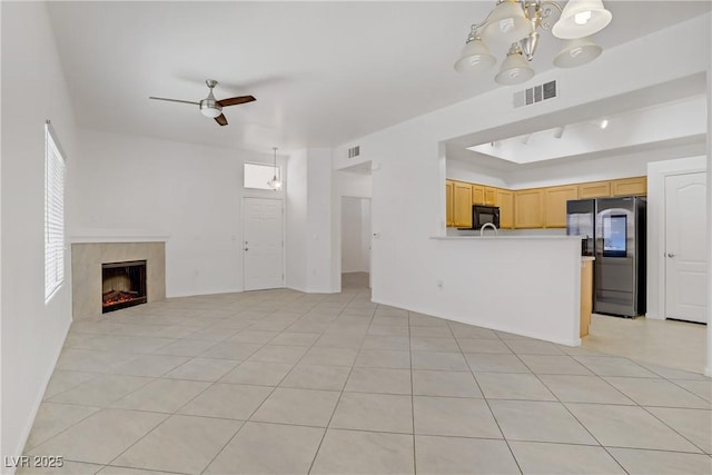 8985 S Durango Dr Unit 1154, Las Vegas, NV 89113 - unfurnished living room with a chandelier, ceiling fan, a tiled fireplace, and light tile patterned floors
