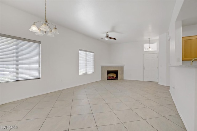 8985 S Durango Dr Unit 1154, Las Vegas, NV 89113 - unfurnished living room featuring healthy amount of natural light, a chandelier, ceiling fan, and a tiled fireplace