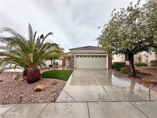 2558 Divine Sky Dr, Henderson, NV 89044 - view of front of house with driveway, an attached garage, and stone siding