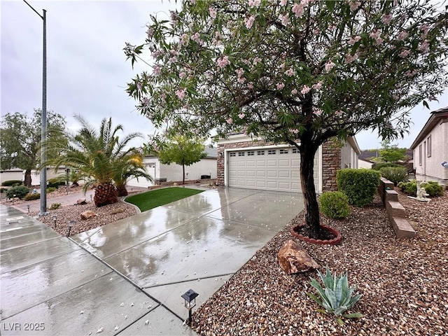 2558 Divine Sky Dr, Henderson, NV 89044 - view of front of property featuring concrete driveway, stone siding, and a garage
