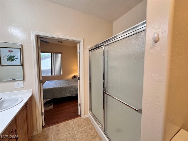 2558 Divine Sky Dr, Henderson, NV 89044 - ensuite bathroom featuring a stall shower, vanity, and tile patterned floors