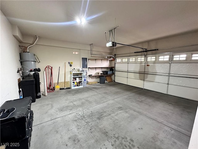 2558 Divine Sky Dr, Henderson, NV 89044 - garage featuring a garage door opener, strapped water heater, and electric panel