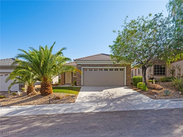 2558 Divine Sky Dr, Henderson, NV 89044 - view of front facade with a garage, stone siding, concrete driveway, a tile roof, and stucco siding