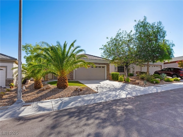 2558 Divine Sky Dr, Henderson, NV 89044 - obstructed view of property with an attached garage, driveway, and stone siding