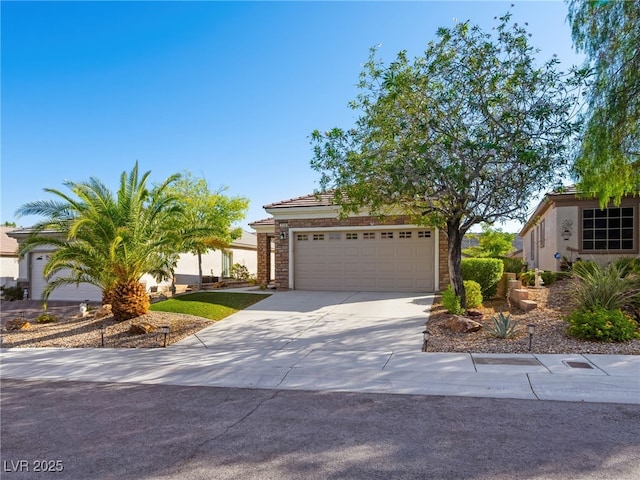 2558 Divine Sky Dr, Henderson, NV 89044 - view of front of property featuring concrete driveway, an attached garage, stucco siding, stone siding, and a tiled roof