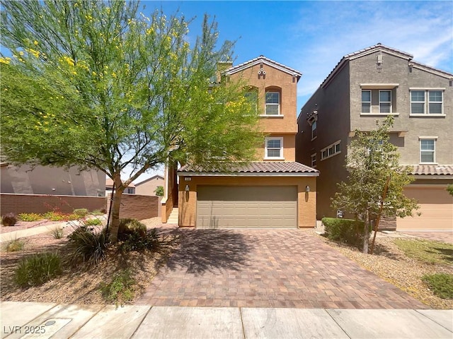 148 Campbelltown Ave, Henderson, NV 89015 - view of front of house with a garage, stucco siding, decorative driveway, and a tile roof
