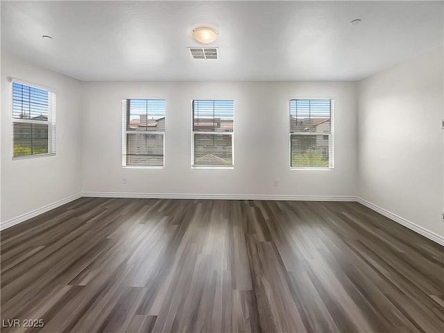 148 Campbelltown Ave, Henderson, NV 89015 - unfurnished room featuring baseboards, dark wood-type flooring, and plenty of natural light