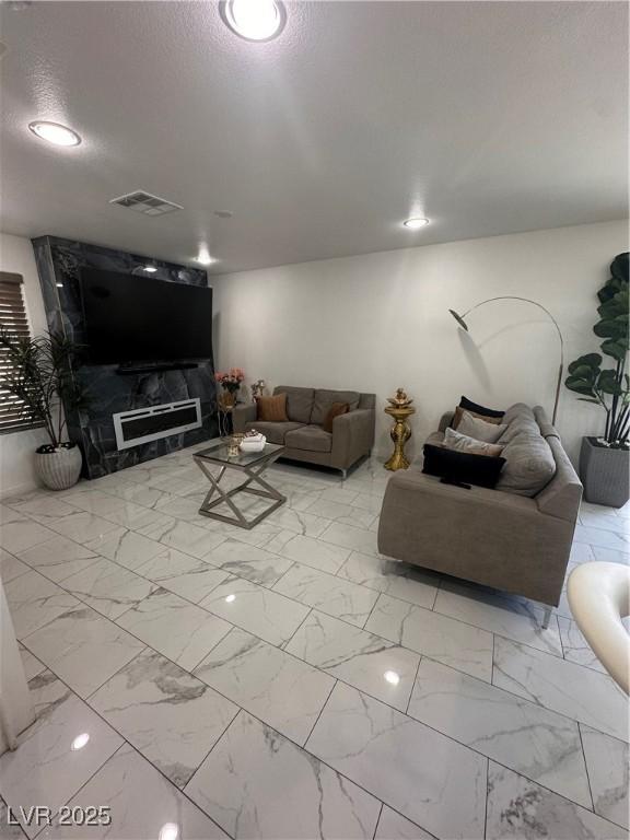 369 Stone Fly Rd, North Las Vegas, NV 89032 - living area featuring marble finish flooring and a textured ceiling