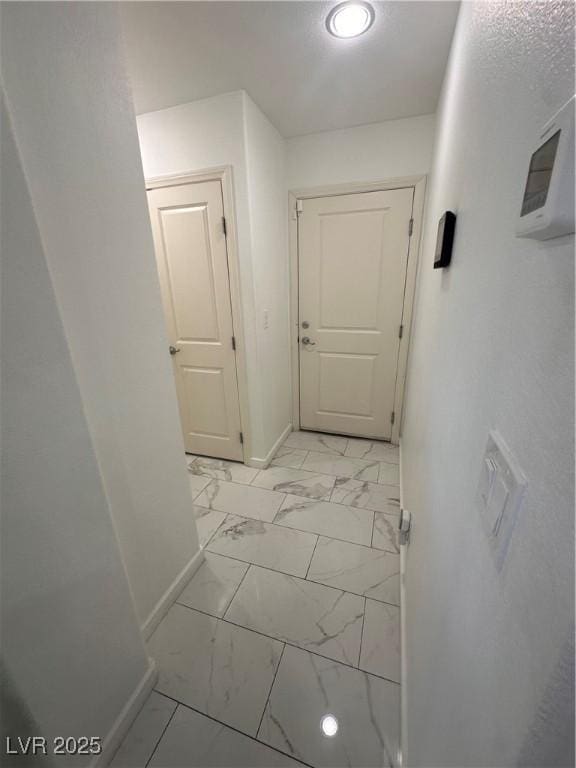 369 Stone Fly Rd, North Las Vegas, NV 89032 - corridor featuring baseboards and light marble finish floors