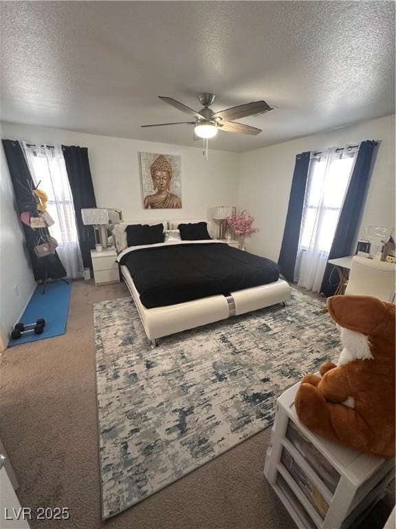 369 Stone Fly Rd, North Las Vegas, NV 89032 - bedroom with multiple windows, carpet, a textured ceiling, and a ceiling fan