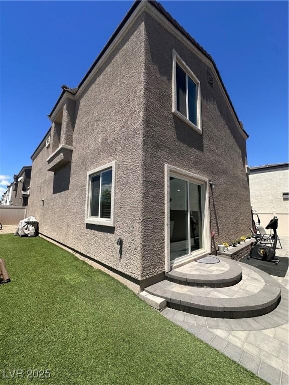 369 Stone Fly Rd, North Las Vegas, NV 89032 - back of house with stucco siding and a patio