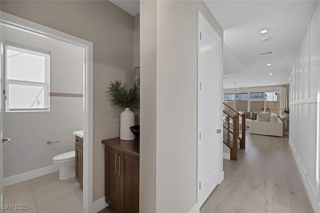 hallway featuring baseboards