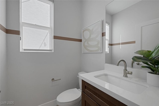 bathroom with toilet and vanity