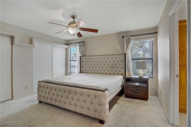 9552 Wooden Pier Way, Las Vegas, NV 89117 - bedroom with light carpet, a ceiling fan, multiple closets, and baseboards