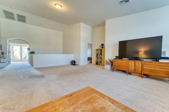 8137 Cape Flattery Ave, Las Vegas, NV 89147 - carpeted living room featuring a high ceiling and french doors