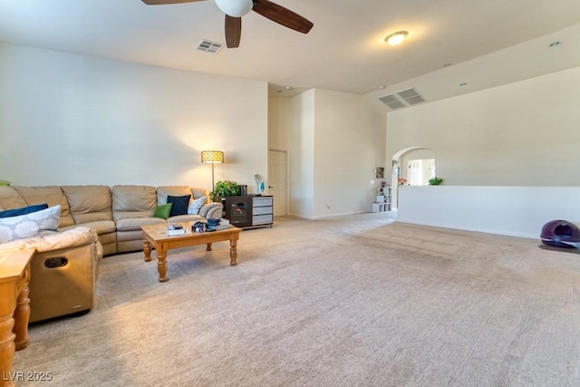 8137 Cape Flattery Ave, Las Vegas, NV 89147 - living room with arched walkways, ceiling fan, light carpet, and baseboards