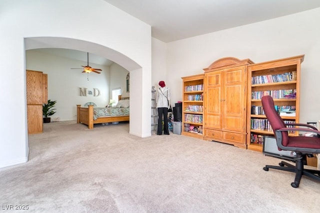 8137 Cape Flattery Ave, Las Vegas, NV 89147 - office area featuring carpet floors, ceiling fan, arched walkways, baseboards, and a high ceiling