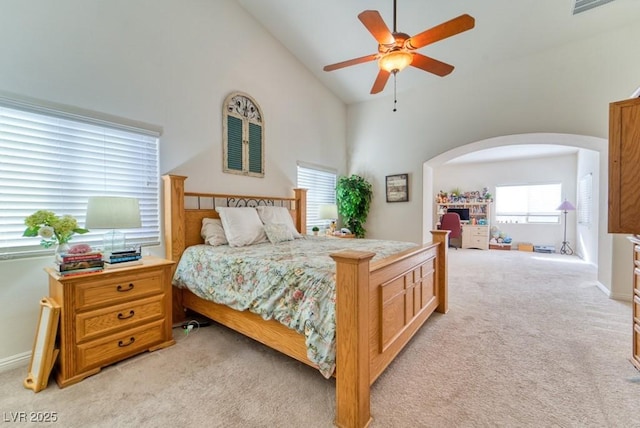 8137 Cape Flattery Ave, Las Vegas, NV 89147 - bedroom featuring light carpet, arched walkways, high vaulted ceiling, and baseboards