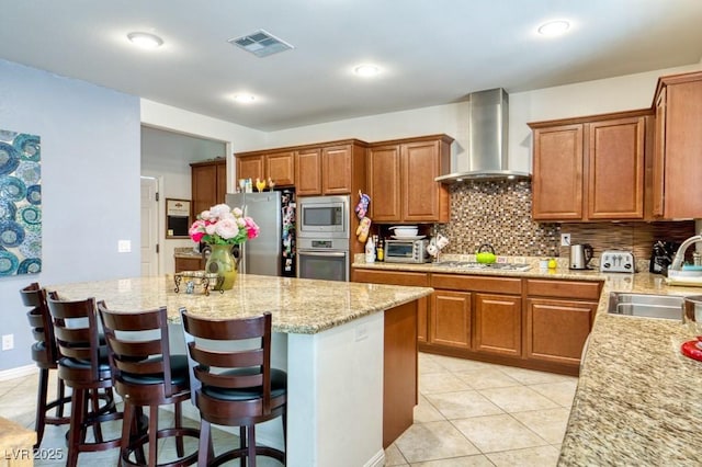 8137 Cape Flattery Ave, Las Vegas, NV 89147 - kitchen featuring wall chimney exhaust hood, stainless steel appliances, a sink, a center island, and backsplash