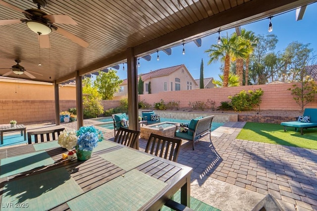 8137 Cape Flattery Ave, Las Vegas, NV 89147 - view of patio with a fenced backyard, a ceiling fan, outdoor dining area, and an outdoor living space with a fire pit