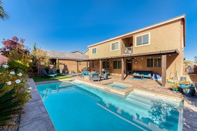 8137 Cape Flattery Ave, Las Vegas, NV 89147 - back of property with an outdoor hangout area, stucco siding, an in-ground hot tub, a balcony, and a patio area