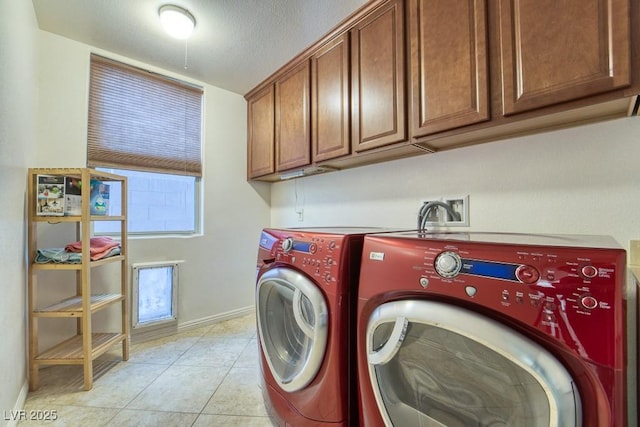 8137 Cape Flattery Ave, Las Vegas, NV 89147 - laundry room featuring washing machine and dryer, cabinet space, baseboards, and light tile patterned flooring