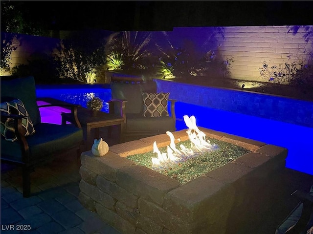 8137 Cape Flattery Ave, Las Vegas, NV 89147 - patio at twilight featuring an outdoor fire pit and fence
