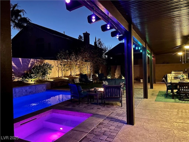 8137 Cape Flattery Ave, Las Vegas, NV 89147 - patio at twilight featuring an in-ground hot tub, a fenced backyard, an outdoor hangout area, and a ceiling fan
