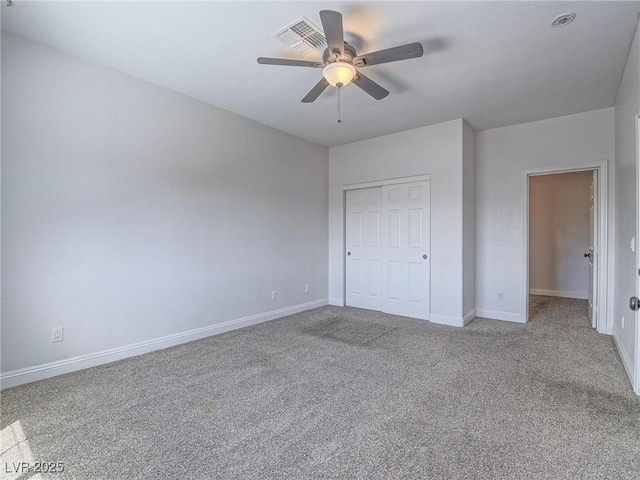 unfurnished bedroom with carpet floors, baseboards, a closet, and a ceiling fan