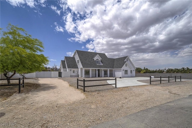 view of front of house with a fenced front yard and a shingled roof