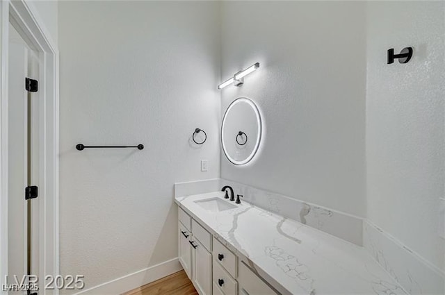 7460 Desert Flame Ct, Las Vegas, NV 89149 - bathroom featuring vanity, baseboards, and wood finished floors