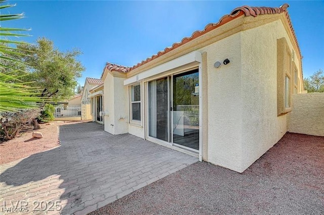 7460 Desert Flame Ct, Las Vegas, NV 89149 - back of house with stucco siding, a patio area, a tile roof, and fence
