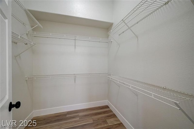 7460 Desert Flame Ct, Las Vegas, NV 89149 - spacious closet featuring wood finished floors
