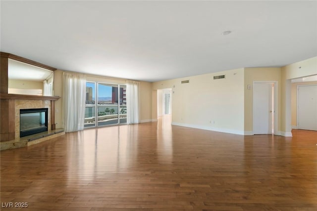 2857 Paradise Rd Unit 802, Las Vegas, NV 89109 - unfurnished living room with wood finished floors, a high end fireplace, and baseboards