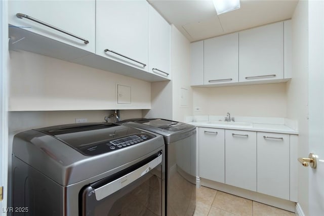 2857 Paradise Rd Unit 802, Las Vegas, NV 89109 - laundry area with cabinet space, separate washer and dryer, and light tile patterned floors